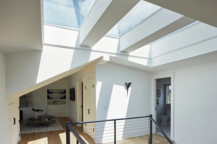 VELUX fixed skylights bringing daylight into a hallway with a stair ladder.