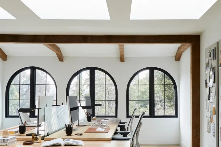 VELUX flat roof skylights over a modern open-plan office space.