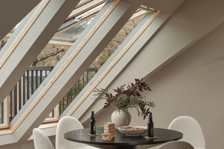 VELUX roof window opened outward from a room with a sloped ceiling.