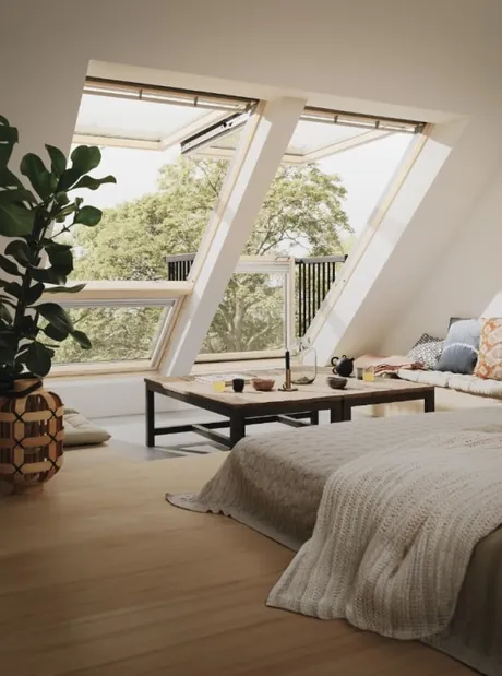 VELUX roof balcony open above a bed, the lower section forming a railed balcony.
