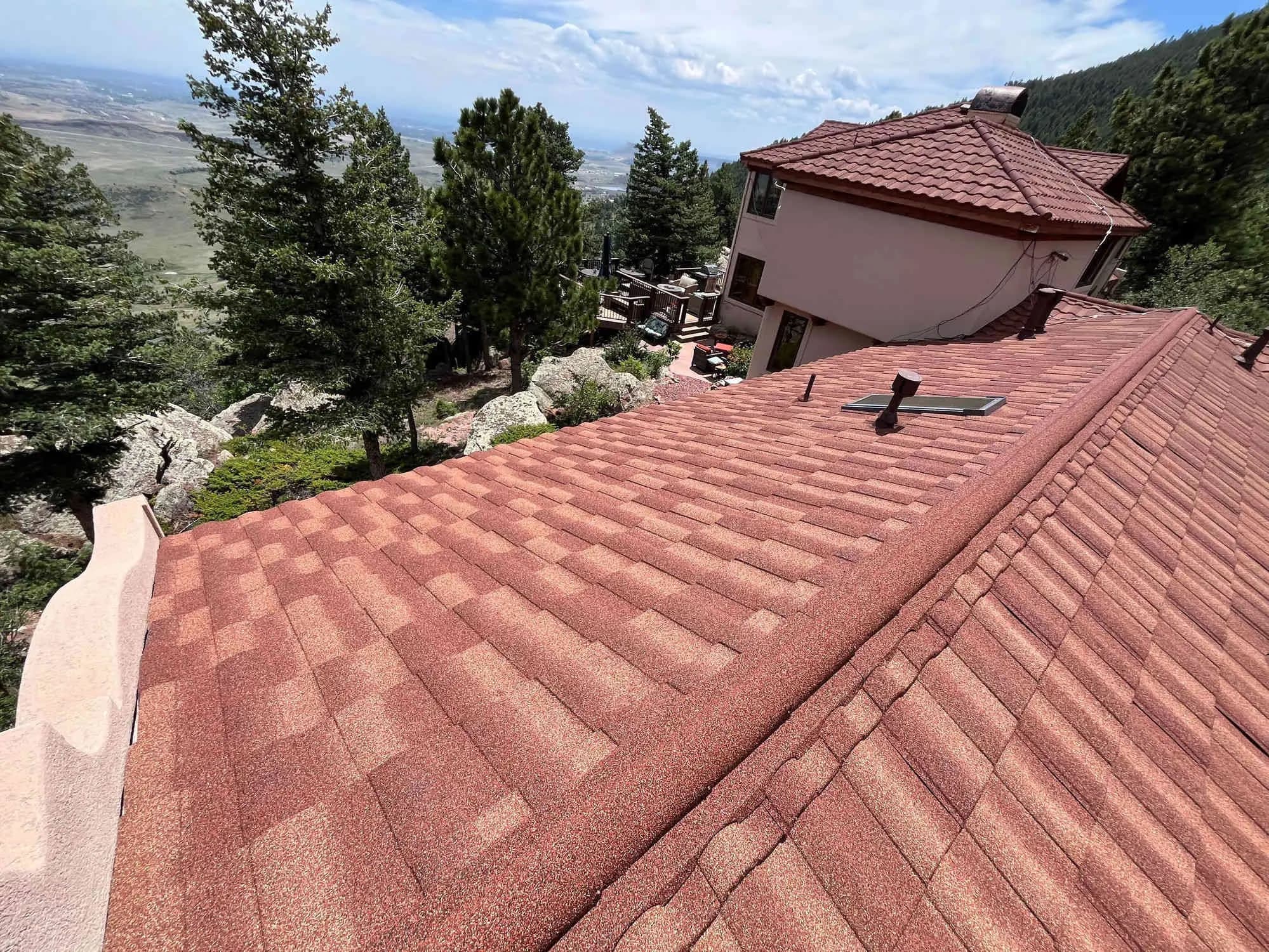 New red roof installed by Red Hawk Roofing on a Colorado foothills home overlooking the Front Range