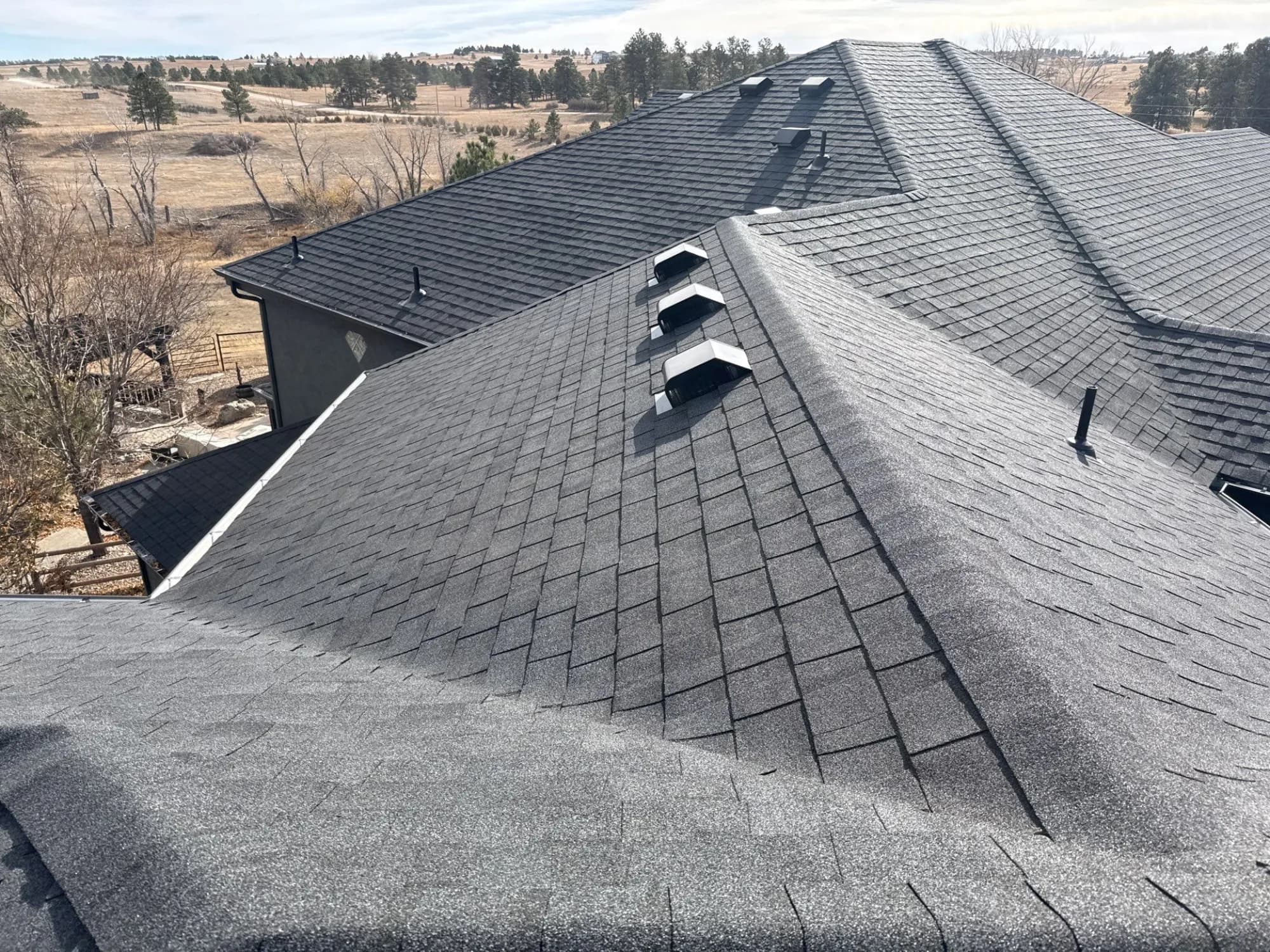 Completed roof replacement on an Elizabeth home backing to open Elbert County land.