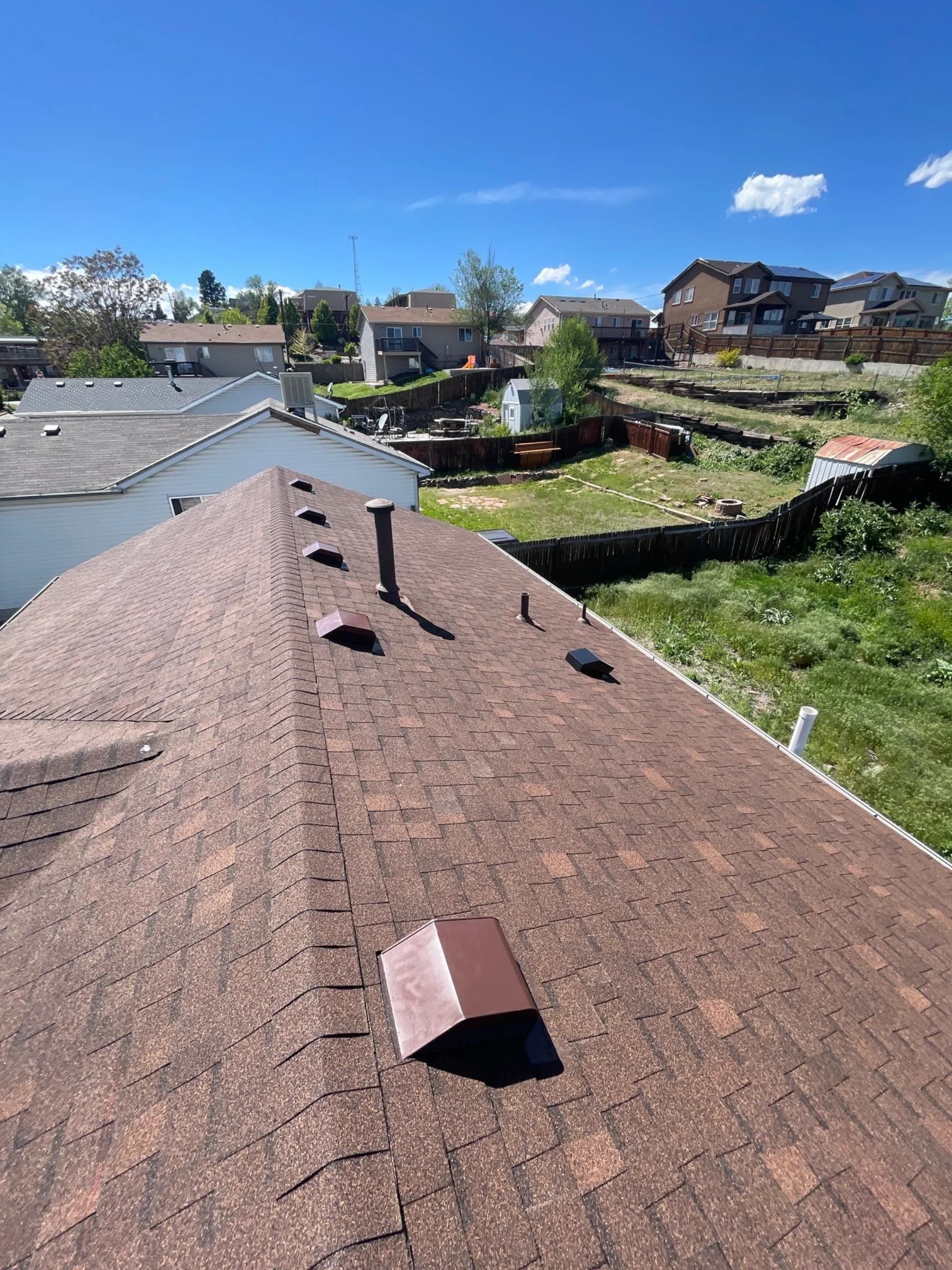 Completed Englewood roof replacement with new box vents set along the ridge.