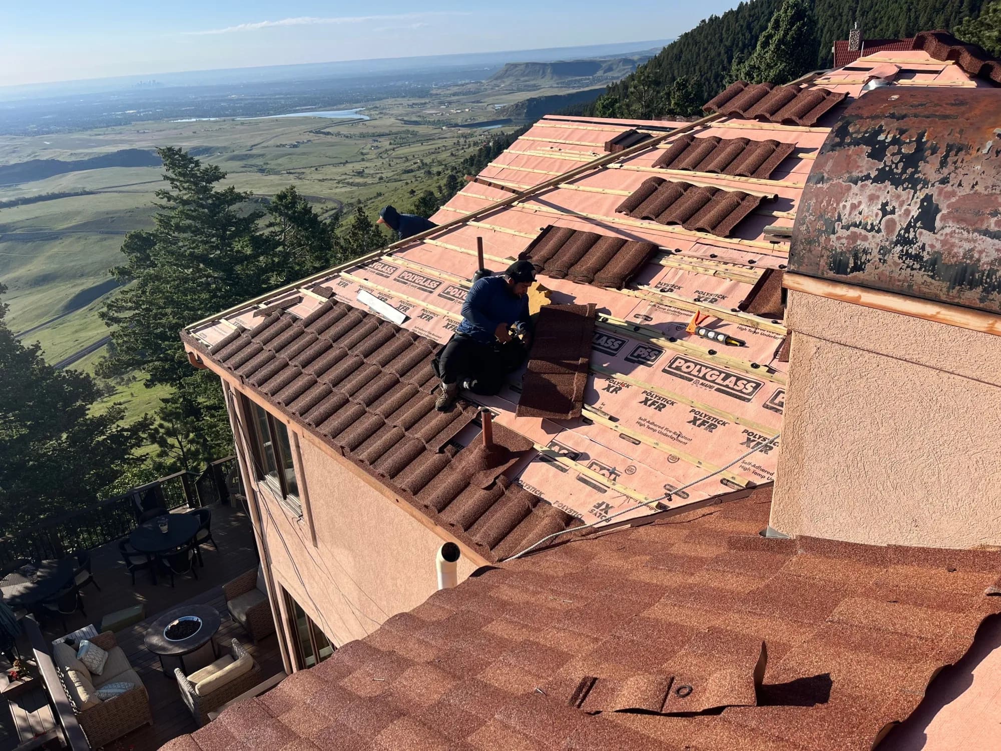 Red Hawk crew installing stone-coated steel panels over self-adhered high-temp underlayment on a Golden foothills home.