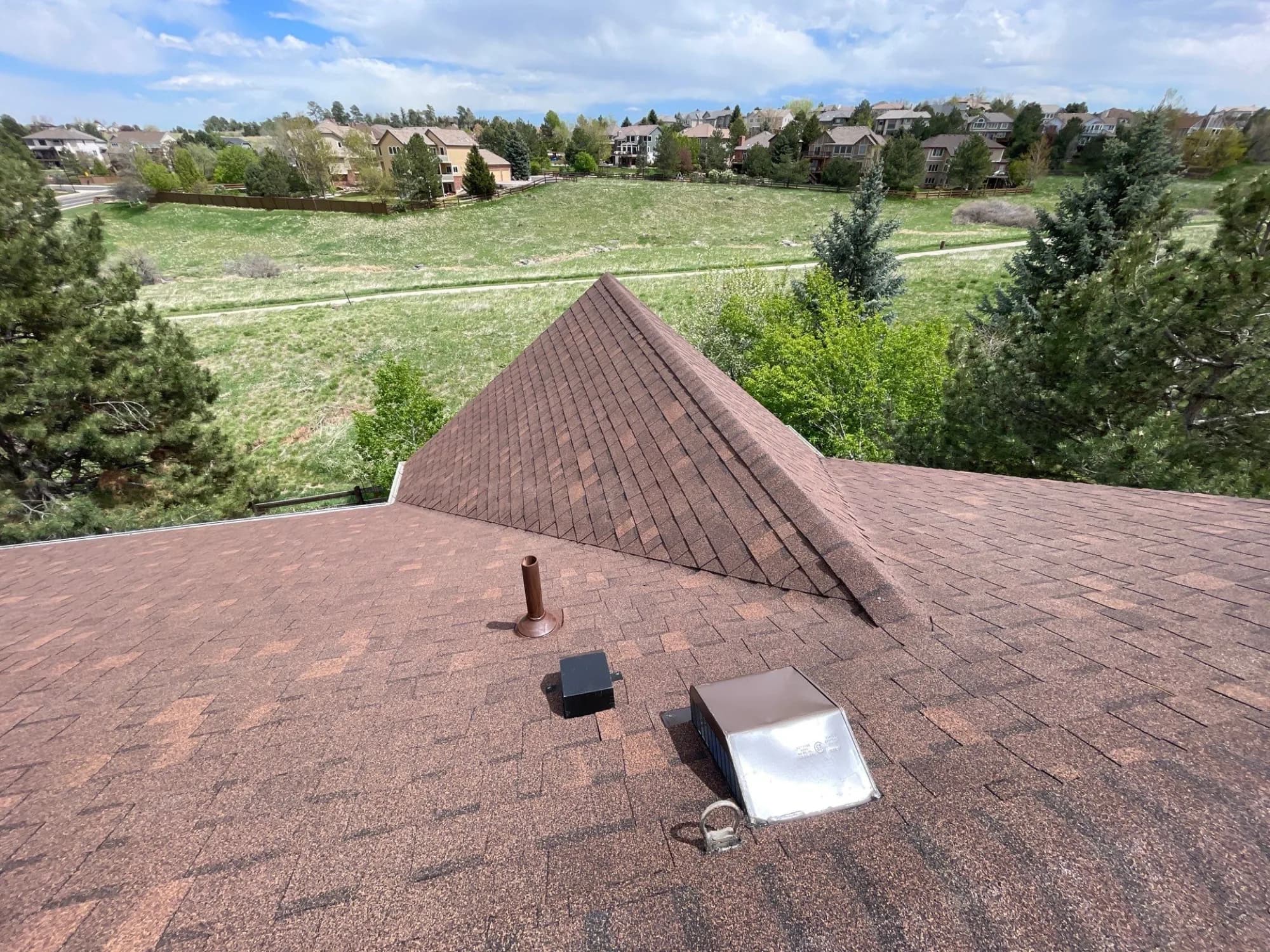 Completed roof replacement on a Highlands Ranch home backing to open space.